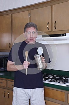 Funny Bachelor Man Cooking Dinner Eat From Tin Can photo