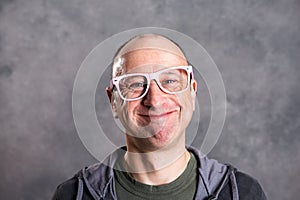 Funny baldheaded man with pink glasses