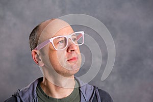 Funny baldheaded man with pink glasses photo