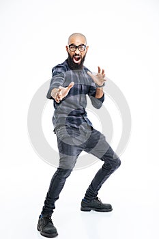 Funny baldheaded young african american man showing karate kick photo