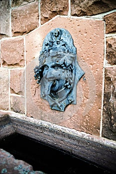 Funny bas-relief of Bacchus head as part of the fountain