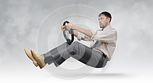 Funny bearded businessman with a steering wheel