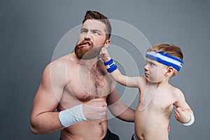 Funny bearded dad and his son fighting
