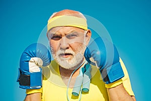 Funny bearded man standing in boxing pose. Elderly man hitting punching bag. Boxing. I love boxing. Portrait of a