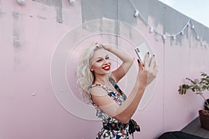 Funny beautiful young blogger girl in a fashionable dress
