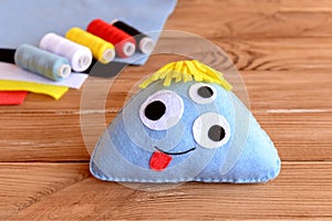 Funny blue felt monster. Halloween hand decoration. DIY soft toy monster with three eyes