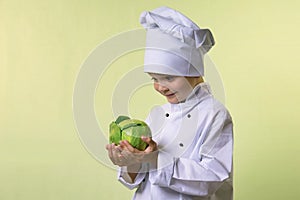 Chef keeps in his hands a cabbage