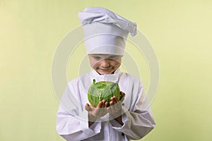 Chef keeps in his hands a cabbage