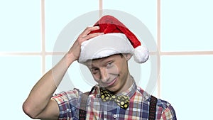 Funny boy in Christmas hat has an idea.