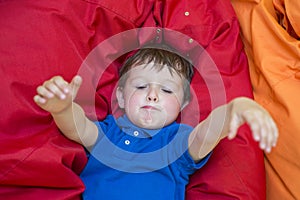 Funny boy grimacing. Child in plays room