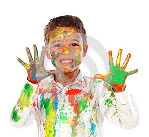 Funny boy with hands and face full of paint