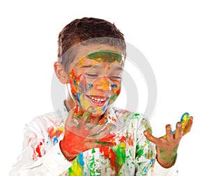 Funny boy with hands and face full of paint