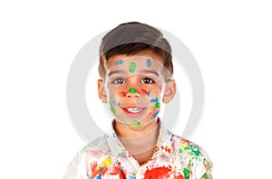 Funny boy with hands and face full of paint