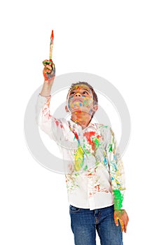 Funny boy with hands and face full of paint