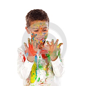 Funny boy with hands and face full of paint