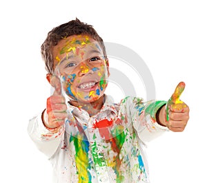 Funny boy with hands and face full of paint saying Ok