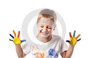 Funny boy with hands painted in colorful paint