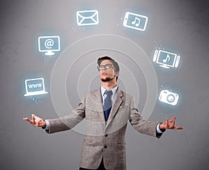 Funny boy juggling with electronic devices icons