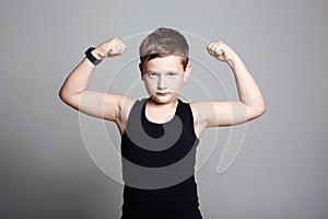 Funny Boy. Little bodybuilder showing his hand biceps muscles
