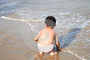 Funny boy playing on the beach