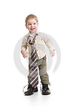 Funny boy playing in big father's shoes isolated