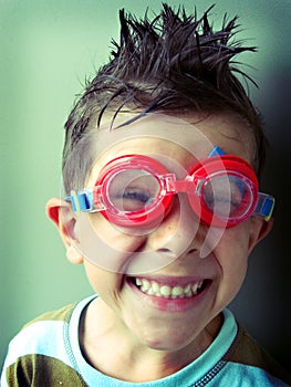 Funny boy smiling in swimming googles