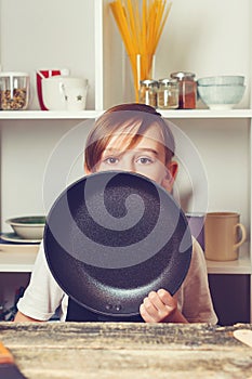 Funny boy wearing apron. Future profession. Chef trying a new recipe. Boy at cooking classes. Child cooking