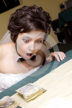 Funny bride looking at stack of mo