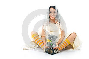 Funny bride wearing sporting shoes with a toy photo