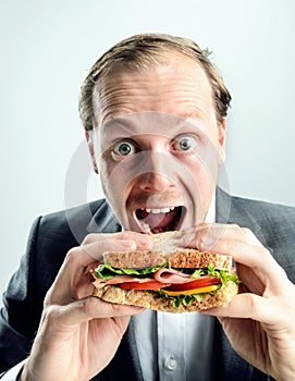 Funny business man eating sandwich