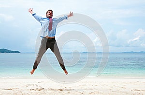 Funny business man jumping on the beach