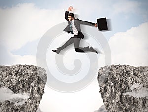 Funny business man jumping over rocks with gap