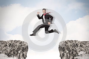 Funny business man jumping over rocks with gap