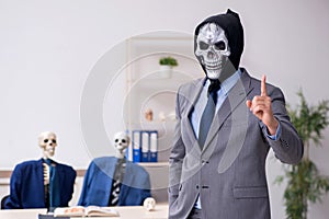 Funny business meeting with devil and skeletons