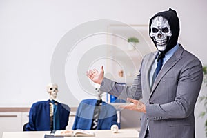 Funny business meeting with devil and skeletons