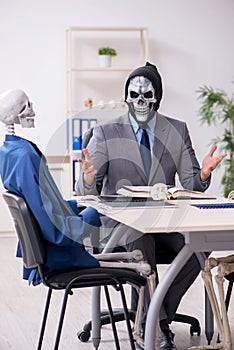 Funny business meeting with devil and skeletons