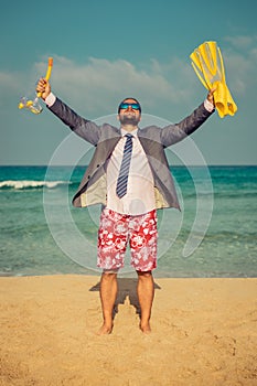 Funny businessman on the beach