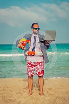 Funny businessman on the beach