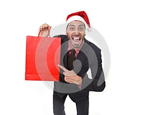 Funny businessman in Christmas Santa hat holding red shopping bag in December and New year sale