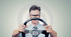 Funny businessman in glasses with a steering wheel