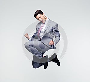 Funny businessman jumping in air