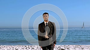 Funny businessman jumping and crossing the beach