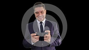 Funny businessman playing in game on the phone and winning, Alpha Channel