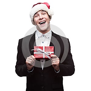 Funny businessman in santa hat holding gift