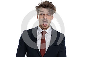 Funny businessman sticking out his tongue and making silly face