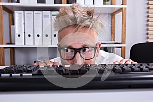 Funny Businessman Hiding Behind Desk