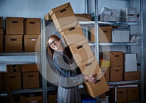 Funny businesswoman holding storage boxes