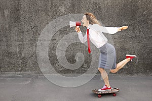 Funny businesswoman riding skateboard outdoor