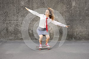 Funny businesswoman riding skateboard outdoor