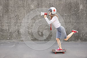 Funny businesswoman riding skateboard outdoor